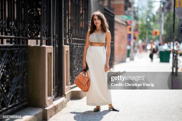 Guest wearing cropped top, maxi skirt is seen outside Collina Strada during New York Fashion Week Spring/Summer 2019 on September 6, 2018 in New York...