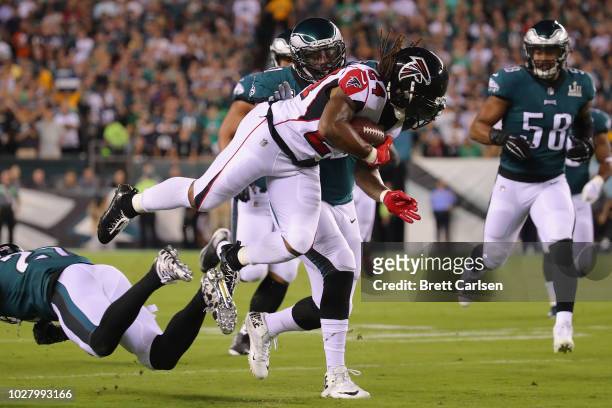 Devonta Freeman of the Atlanta Falcons is tackled by Malcolm Jenkins of the Philadelphia Eagles during the first half at Lincoln Financial Field on...