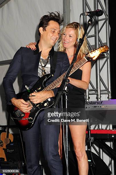 Jamie Hince and Kate Moss perform at a benefit evening for The Hoping Foundation on July 10, 2010 in London, England.