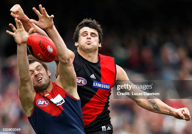Jared Rivers of the Demons attempts a mark against Jay Neagle of the Bombers during the round 15 AFL match between the Melbourne Demons and the...