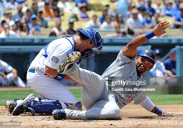 Marlon Byrd of the Chicago Cubs is safe at homeplate in the second inning against A.J. Ellis of the Los Angeles Dodgers at Dodger Stadium on July 10,...