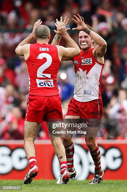 Rhyce Shaw of the Swans celebrates with Jude Bolton after kicking a goal during the round 15 AFL match between the Sydney Swans and the North...