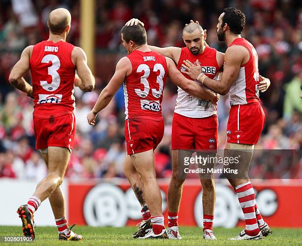 Rhyce Shaw of the Swans celebrates with team mates after kicking a goal during the round 15 AFL match between the Sydney Swans and the North...