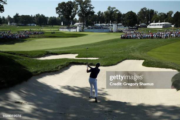Jordan Spieth of the United States plays a shot from a bunker on the tenth hole during the first round of the BMW Championship at Aronimink Golf Club...