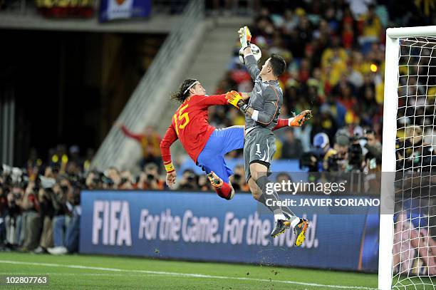 Switzerland's goalkeeper Diego Benaglio deflects the ball as Spain's defender Sergio Ramos tries for a chance on goal during their Group H first...