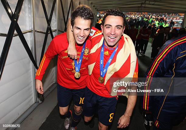 Cesc Fabregas and Xavi Hernandez celebrate in the tunnel after the 2010 FIFA World Cup South Africa Final match between Netherlands and Spain at...