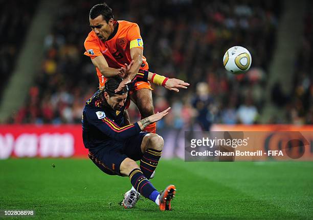 Giovanni Van Bronckhorst of the Netherlands challenges Sergio Ramos of Spain during the 2010 FIFA World Cup South Africa Final match between...