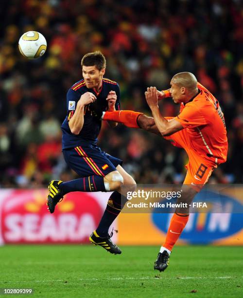 Xabi Alonso of Spain is fouled by Nigel De Jong of the Netherlands during the 2010 FIFA World Cup South Africa Final match between Netherlands and...