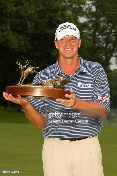 Steve Stricker poses with the winner's trophy following the final round of the John Deere Classic at TPC Deere Run on July 11, 2010 in Silvis,...