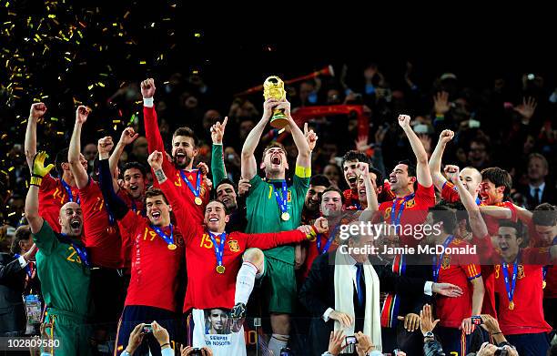 Iker Casillas of Spain celebrates lifting the World Cup with team mates during the 2010 FIFA World Cup South Africa Final match between Netherlands...