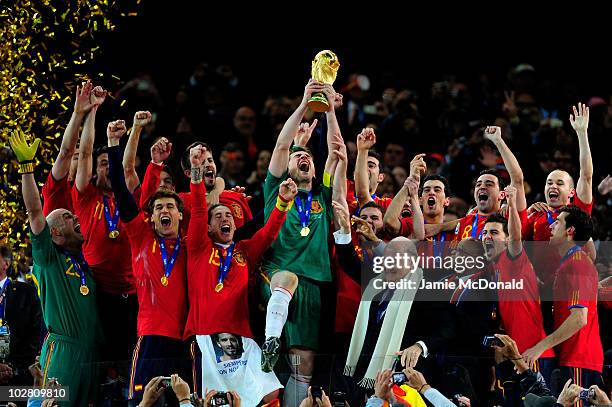 Iker Casillas of Spain celebrates lifting the World Cup with team mates during the 2010 FIFA World Cup South Africa Final match between Netherlands...