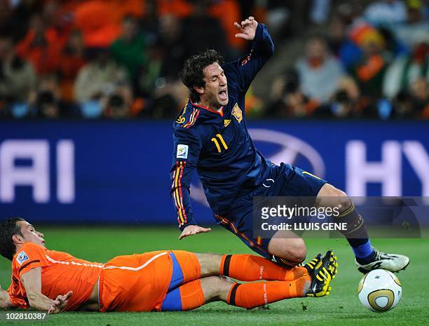 Spain's defender Joan Capdevila is tackled by Netherlands' striker Robin van Persie during the 2010 World Cup football final Netherlands vs. Spain on...