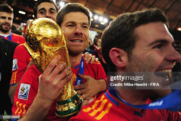 Xabi Alonso of Spain holds the World Cup after the 2010 FIFA World Cup South Africa Final match between Netherlands and Spain at Soccer City Stadium...