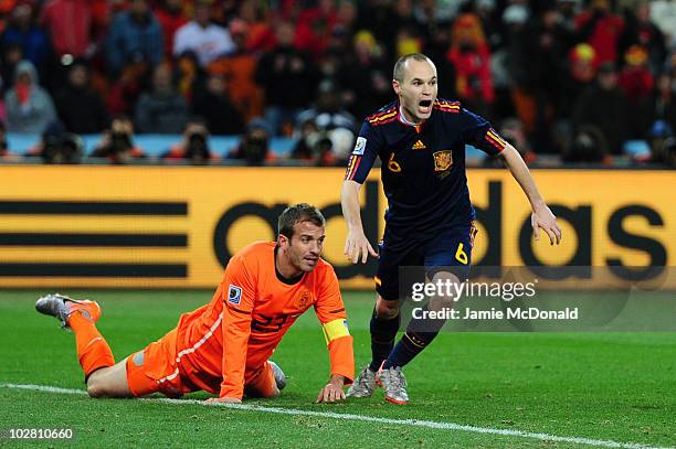 Andres Iniesta of Spain celebrates after scoring the winning goal as Rafael Van der Vaart of the Netherlands looks on during the 2010 FIFA World Cup...