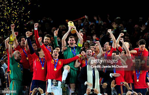 Iker Casillas of Spain celebrates as he lifts the World Cup with team mates during the 2010 FIFA World Cup South Africa Final match between...