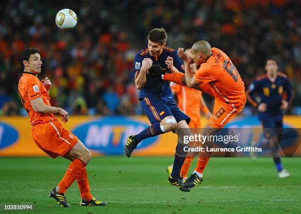 Nigel De Jong of the Netherlands tackles Xabi Alonso of Spain during the 2010 FIFA World Cup South Africa Final match between Netherlands and Spain...