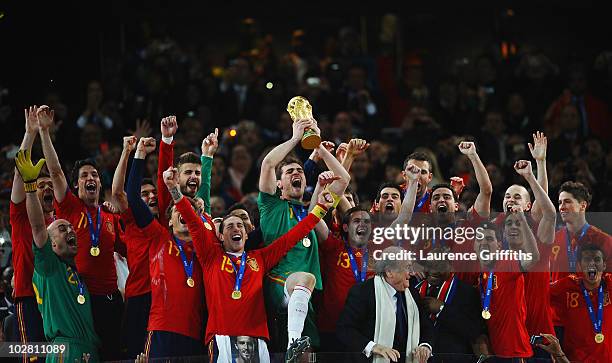 President Jospeph Sepp Blatter and South Africa President Jacob Zuma present the World Cup trophy to Iker Casillas, captain of Spain, following the...