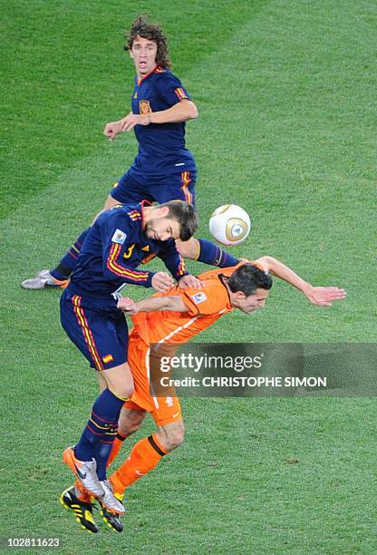 Spain's defender Gerard Pique heads the ball ahead of Netherlands' striker Robin van Persie during the 2010 World Cup football final Netherlands vs....