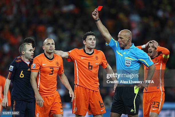 Referee Howard Webb shows the red card to John Heitinga of the Netherlands during the 2010 FIFA World Cup South Africa Final match between...