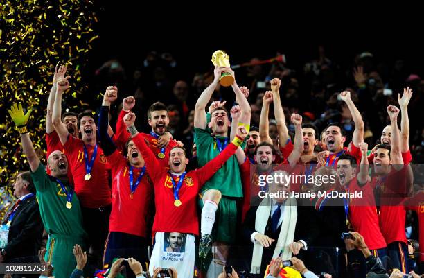 Iker Casillas of Spain celebrates lifting the World Cup with team mates during the 2010 FIFA World Cup South Africa Final match between Netherlands...