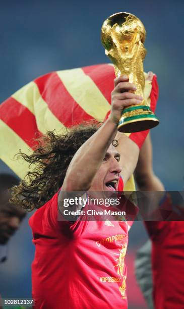 Carles Puyol of Spain lifts the World Cup trophy as the Spain team celebrate victory following the 2010 FIFA World Cup South Africa Final match...
