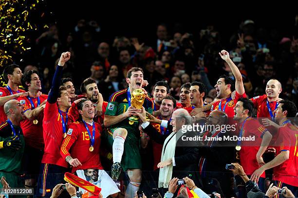 Iker Casillas of Spain celebrates as he is presented the World Cup by FIFA President Joseph Sepp Blatter and President of South Africa Jacob Zuma...