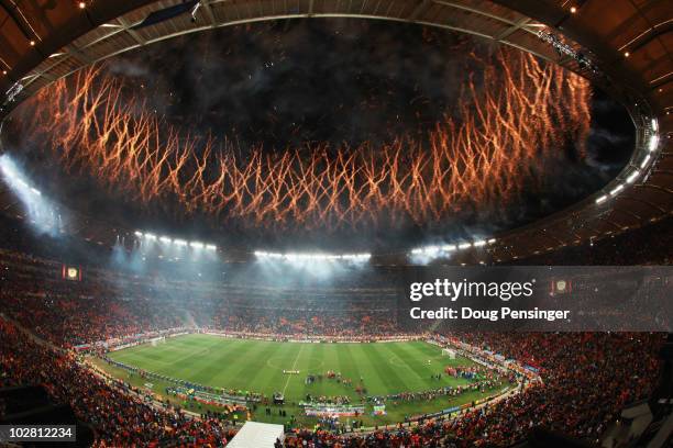 Fireworks explode as the Spain team celebrate victory with the World Cup trophy following the 2010 FIFA World Cup South Africa Final match between...