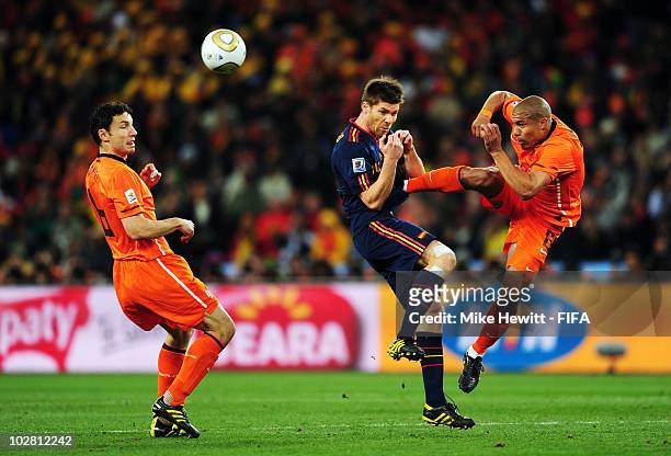 Xabi Alonso of Spain is fouled by Nigel De Jong of the Netherlands during the 2010 FIFA World Cup South Africa Final match between Netherlands and...