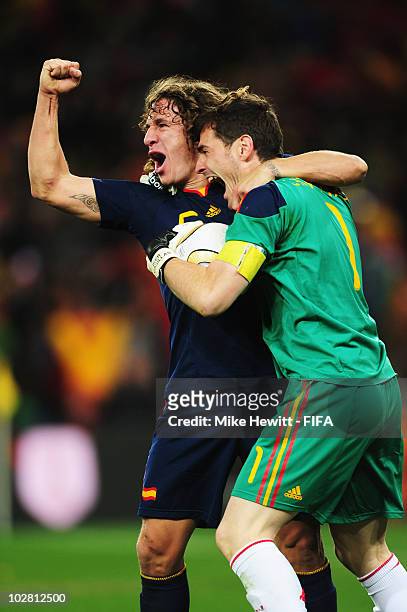 Carles Puyol and Iker Casillas of Spain celebrate winning the World Cup after the 2010 FIFA World Cup South Africa Final match between Netherlands...