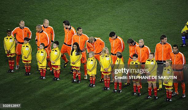 Netherlands's national football team players pose with escort children before the 2010 World Cup football final between the Netherlands and Spain on...
