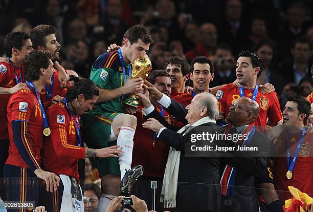 President Jospeph Sepp Blatter and South Africa President Jacob Zuma present the World Cup trophy to Iker Casillas, captain of Spain, following the...