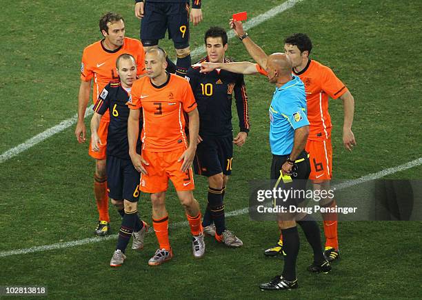 Referee Howard Webb shows John Heitinga of the Netherlands a red card following his second bookable offence during the 2010 FIFA World Cup South...