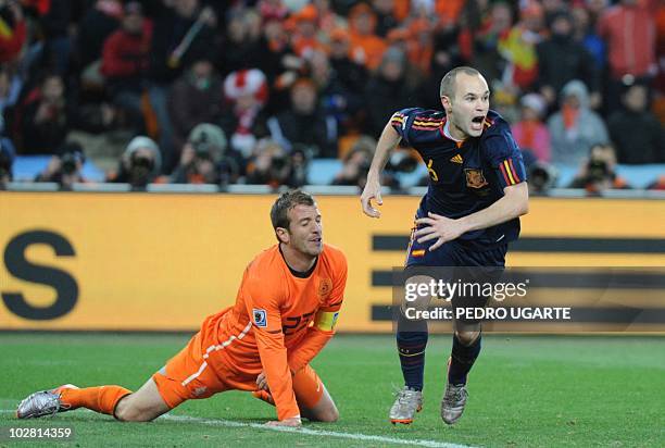 Spain's midfielder Andrés Iniesta celebrates after he scores the winning goal during extra time as Netherlands' midfielder Rafael van der Vaart...