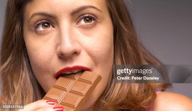 girl stealing a bite of chocolate - milk chocolate stock pictures, royalty-free photos & images