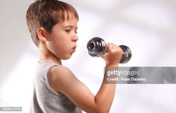 young boy using weights to protect himself against bullying - thinness obsession stock pictures, royalty-free photos & images