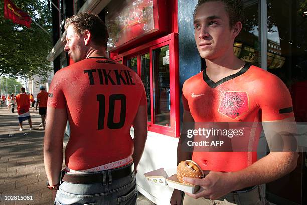 Dutch fans with orange jerseys painted on their torso react in Rotterdam as the Netherlands football team lose the final match in the 2010 South...