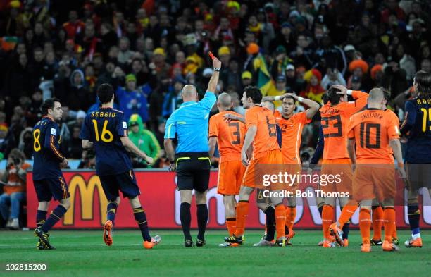 Referee Howard Webb shows the red card and sends off John Heitinga of the Netherlands during the 2010 FIFA World Cup Final between the Netherlands...