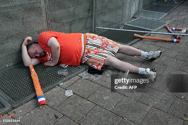Dutch fan lies on the ground in Rotterdam after the Netherlands football team lost the final match in the 2010 South Africa World Cup against Spain...
