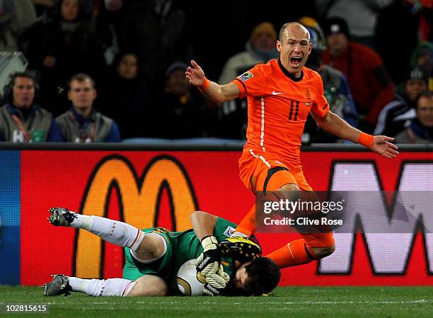 Arjen Robben of the Netherlands reacts to the referee as Iker Casillas of Spain collects the ball during the 2010 FIFA World Cup South Africa Final...