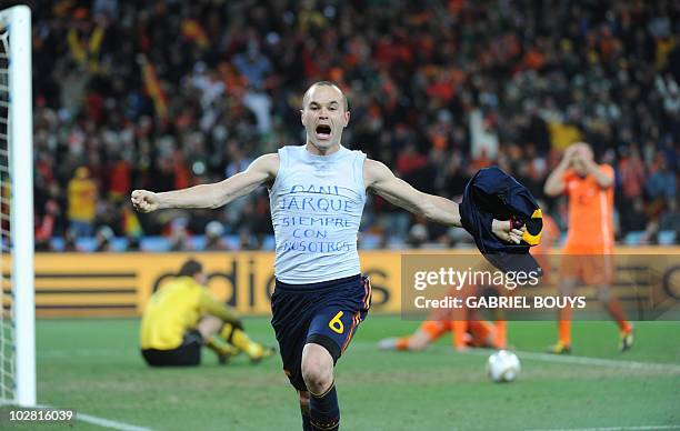 Spain's midfielder Andrés Iniesta celebrates after scoring in extra time of the 2010 FIFA football World Cup final between the Netherlands and Spain...