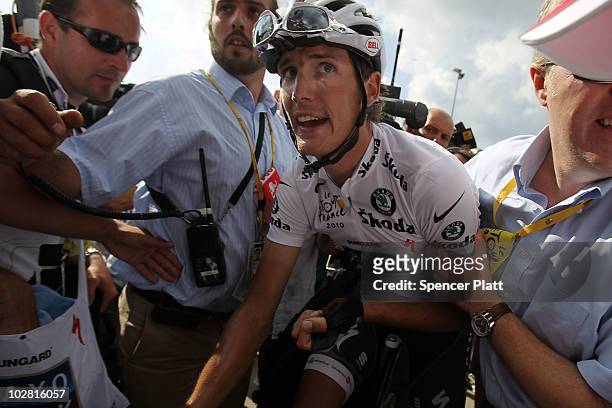 Andy Schleck of Luxembourg from team Saxo Bank is surrounded by the media and his team after winning stage eight of the Tour de France July 11, 2010...