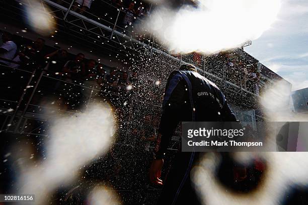 Mark Webber of Australia and Red Bull Racing celebrates with team mates in the paddock after winning the British Formula One Grand Prix at...