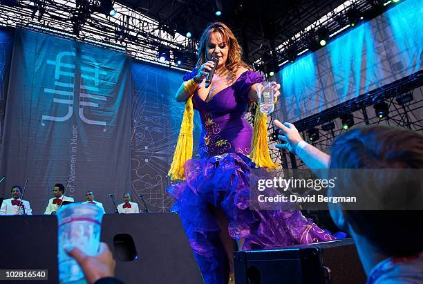 Jenni Rivera gives tequila to audience members at Lilith 2010 at Verizon Wireless Amphitheater on July 10, 2010 in Irvine, California.
