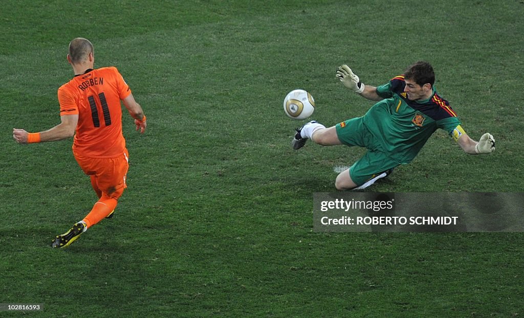 Spain's goalkeeper Iker Casillas (R) pul