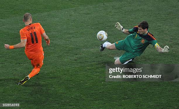 Spain's goalkeeper Iker Casillas pulls off a save with his legs from a shot by the Netherlands' striker Arjen Robben during the 2010 World Cup...