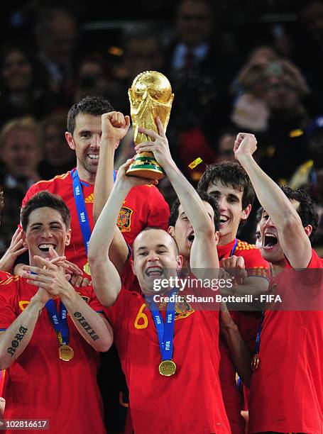 Andres Iniesta of Spain lifts the World Cup after the 2010 FIFA World Cup South Africa Final match between Netherlands and Spain at Soccer City...