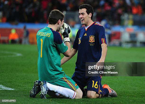 Iker Casillas, captain of Spain, celebrates victory with Sergio Busquets at the final whistle during the 2010 FIFA World Cup South Africa Final match...