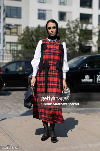 Mademoiselle Meme is seen on the street attending New York Fashion Week SS19 wearing a red/black plaid dress on September 6, 2018 in New York City.
