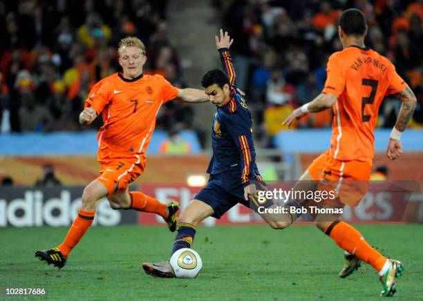 Pedro of Spain shoots between Dirk Kuyt and Gregory Van Der Wiel of the Netherlands during the 2010 FIFA World Cup Final between the Netherlands and...