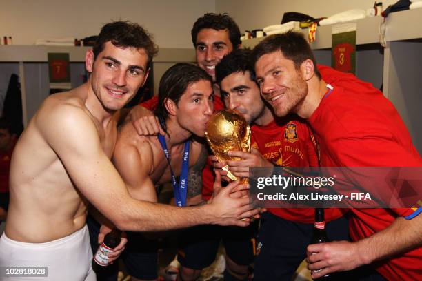 Iker Casillas, Sergio Ramos, Alvaro Arbeloa, Raul Albiol and Xabi Alonso of Spain pose with the trophy in the Spanish dressing room after they won...